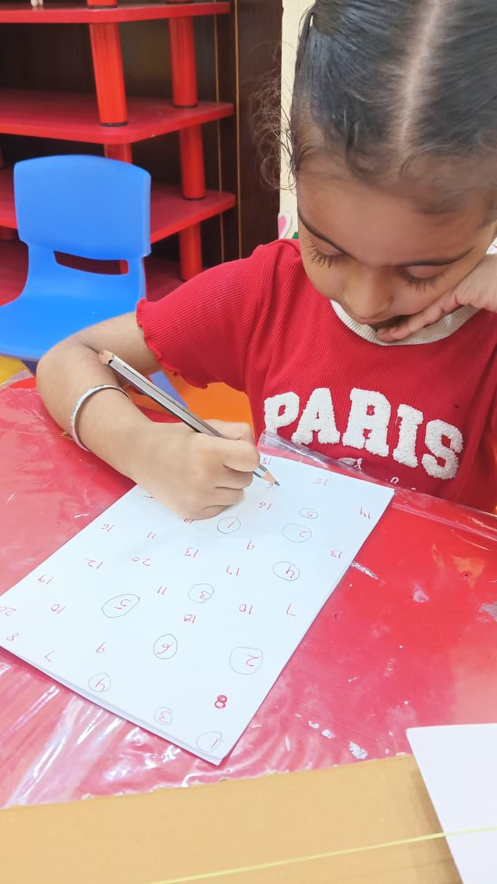 Child receiving supervised learning support during daycare at Kidzee Sector 12 Dwarka